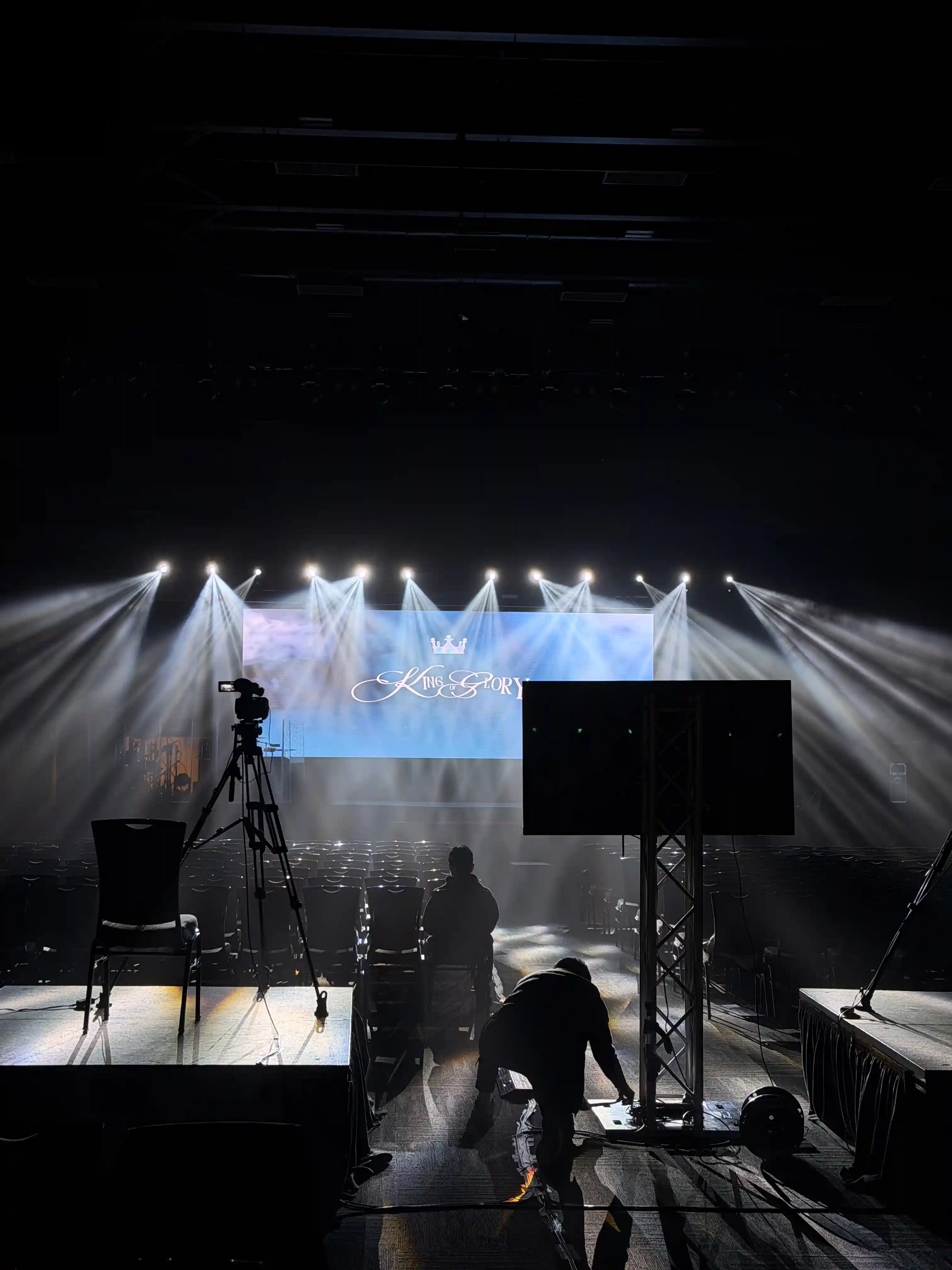 Stage lighting setup with truss and spotlights during live event production