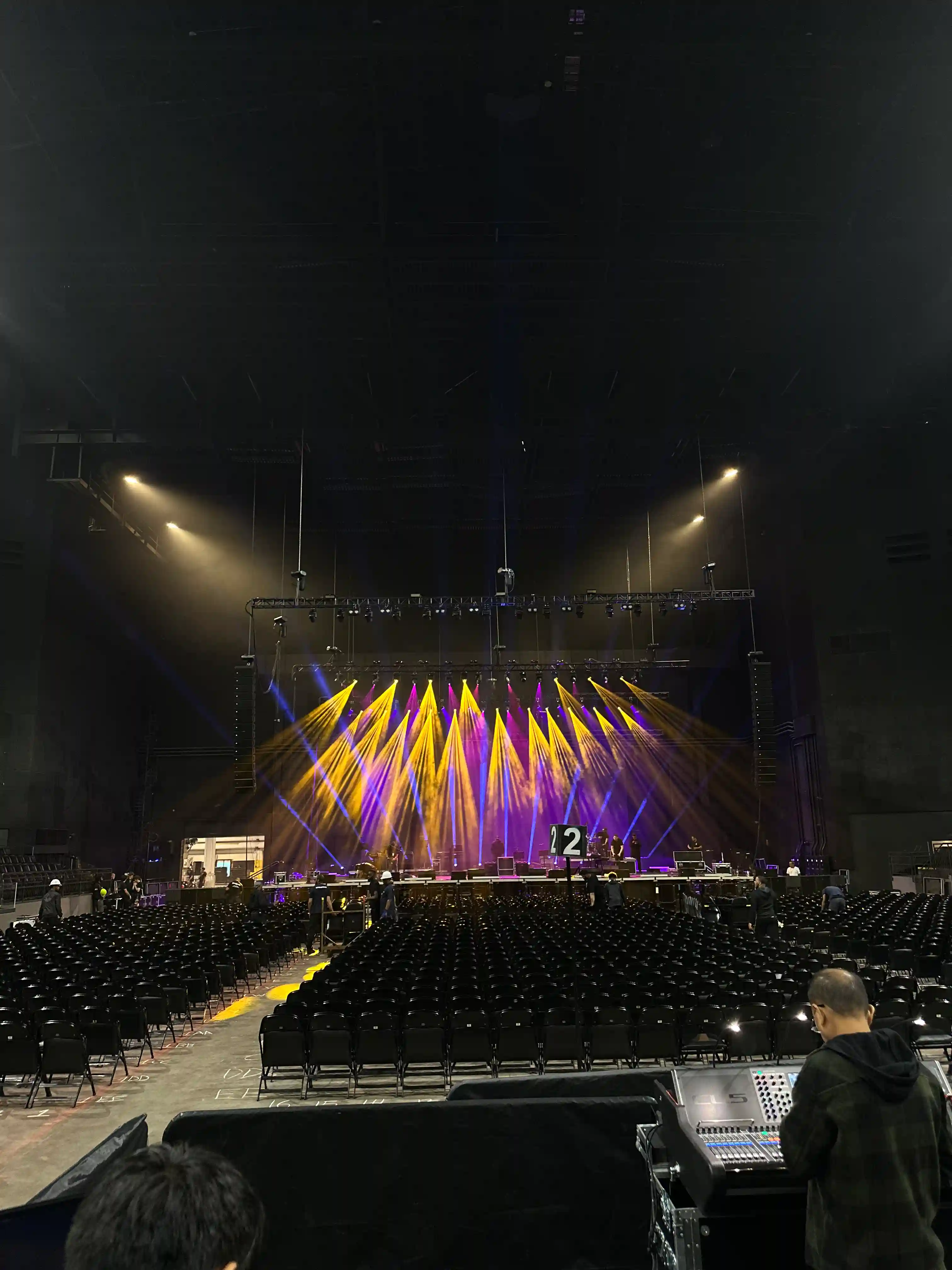 Empty concert venue with colorful pre-show stage lighting and seating
