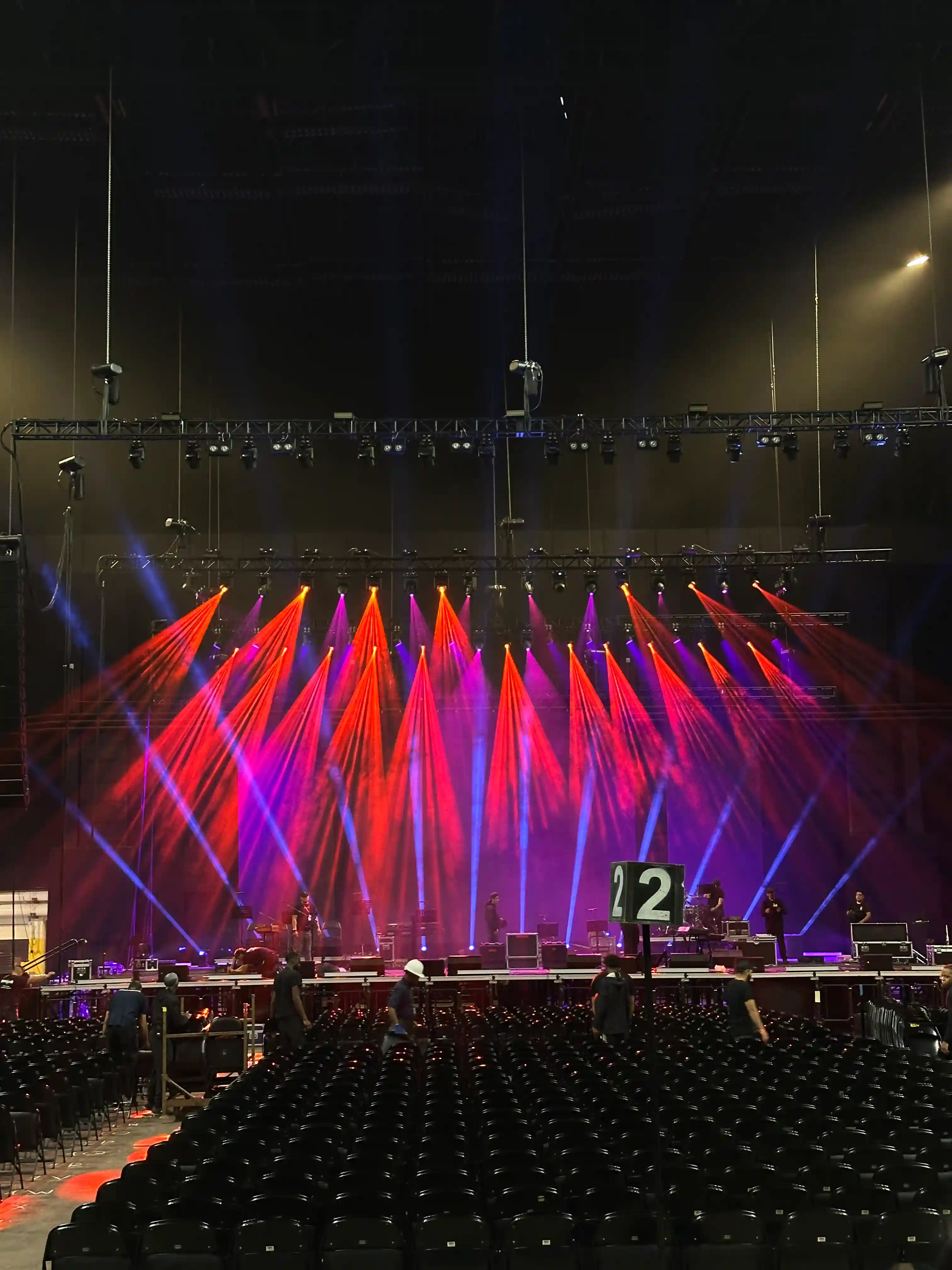 Large concert venue featuring red and yellow professional stage lighting